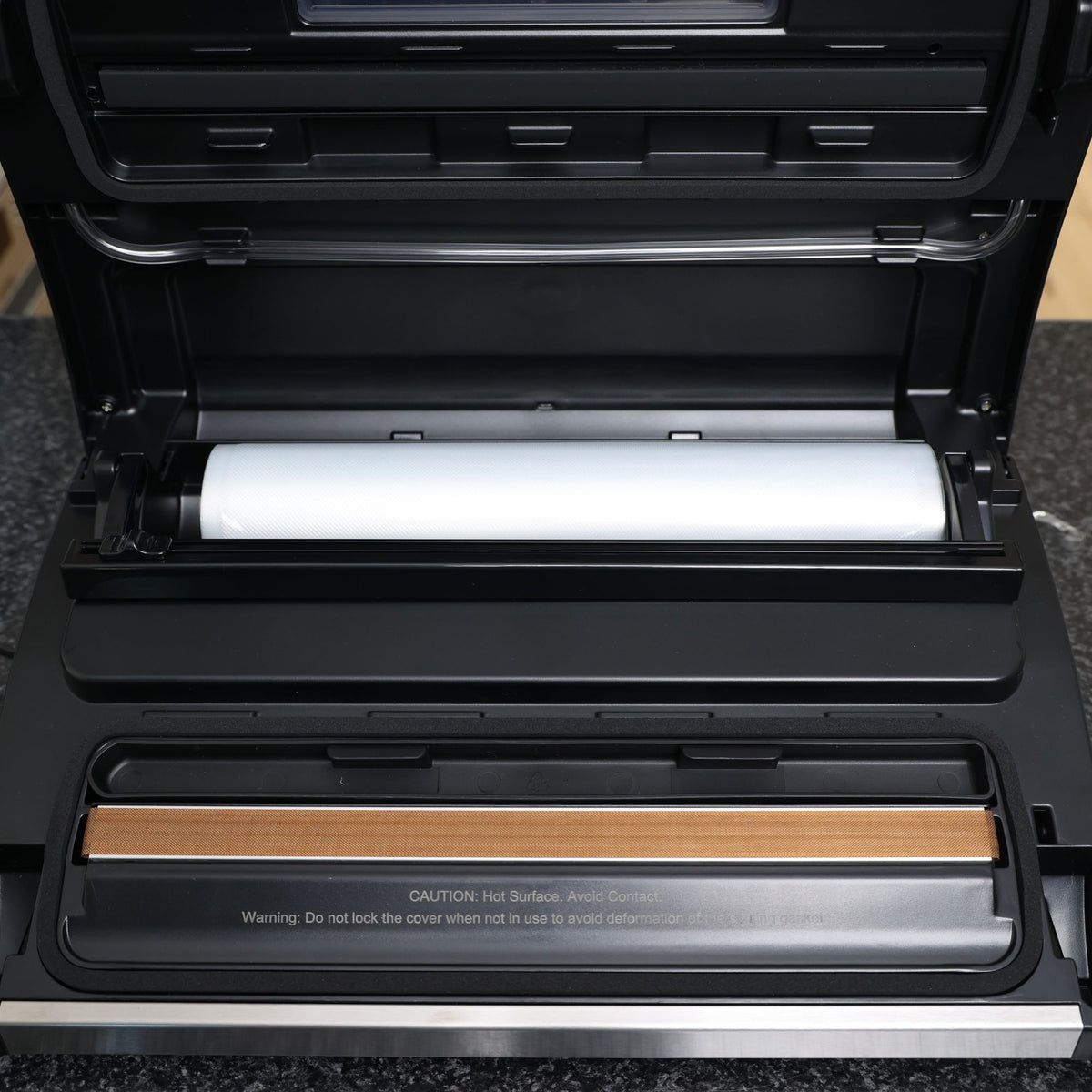 Liquid Ready Vac Sealer Showing Lid Opened with Roll in Roll holder showing heat seal bar double seal, removable drip tray, roll cutter and airhose tube.