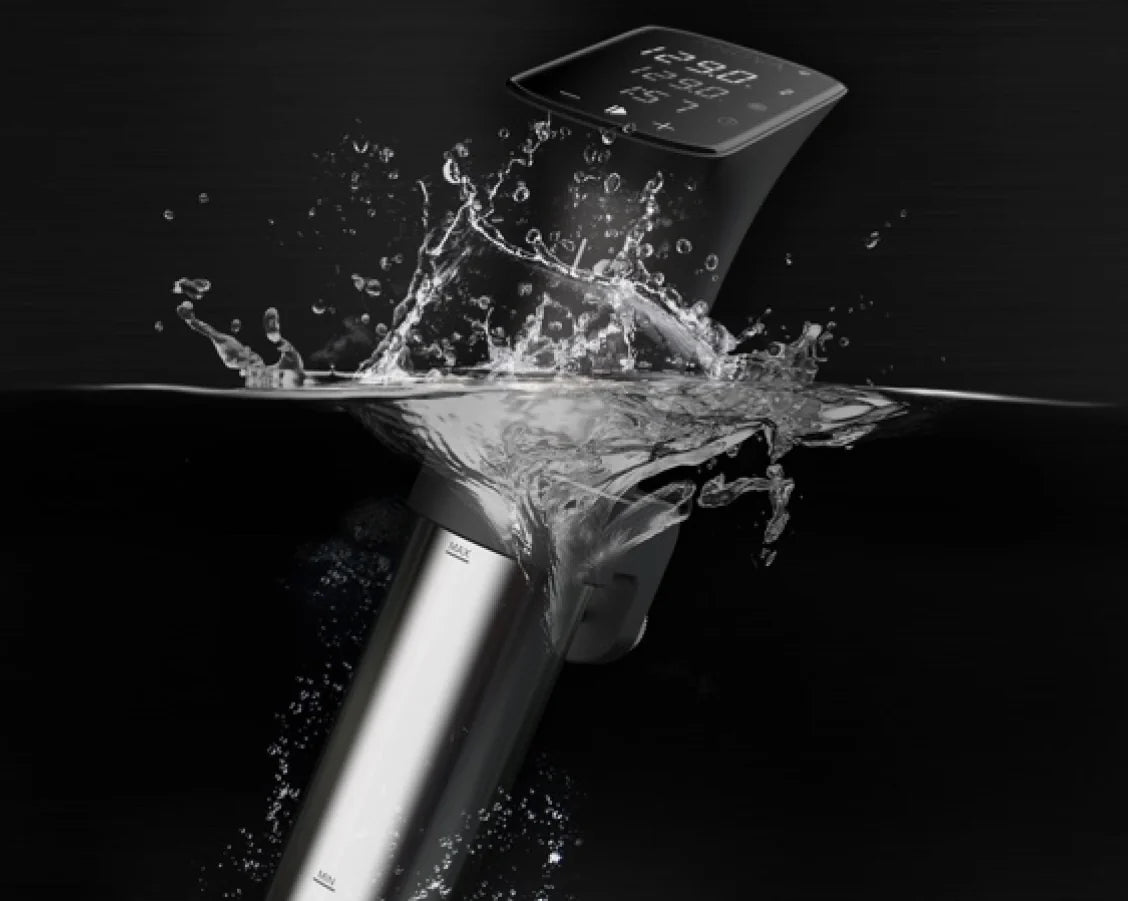 Anova Precision Cooker Pro splashing into water, showcasing its IPX7 waterproof rating and durable stainless steel design with digital display.