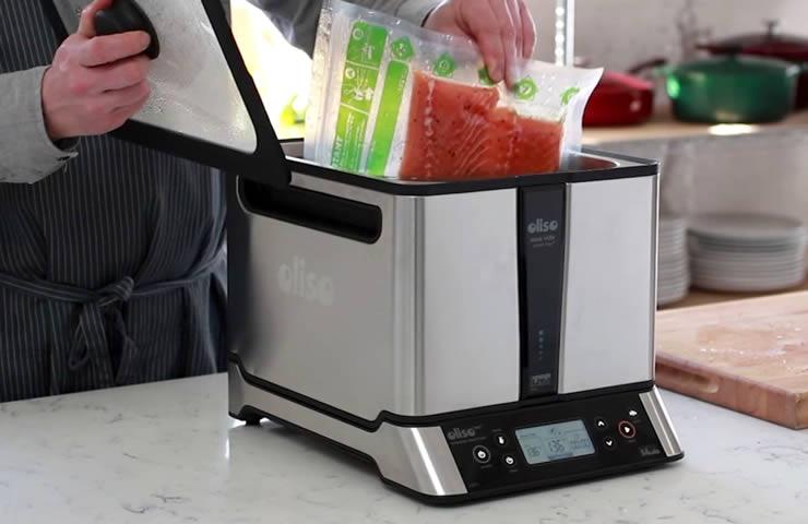Oliso Sous Vide Smart Hub Induction Cooker with Bonus PolyScience Smoking Gun Sous Vide Machine Oliso Inserting Food